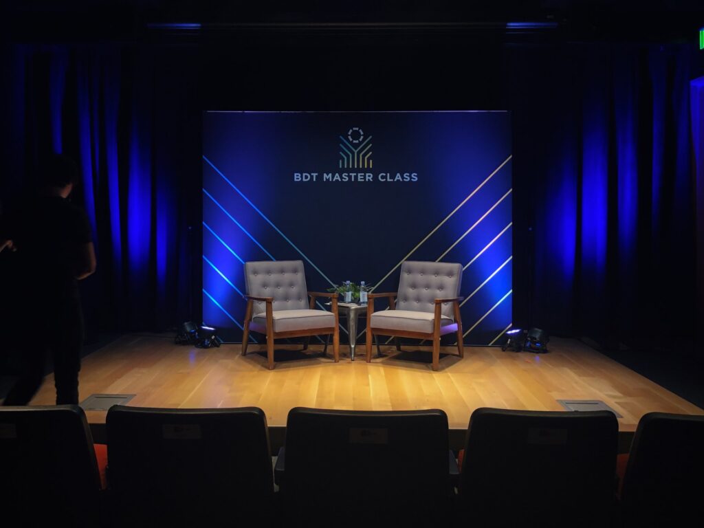 Stage with two chairs and a back blue light