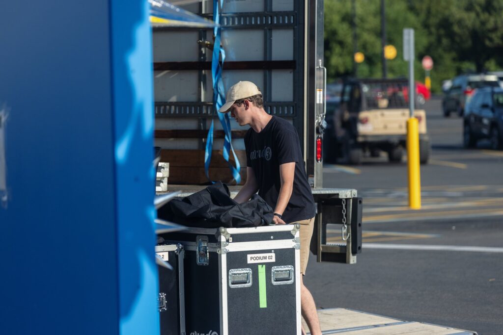 One of our technicians pushes cases outside next to a truck.